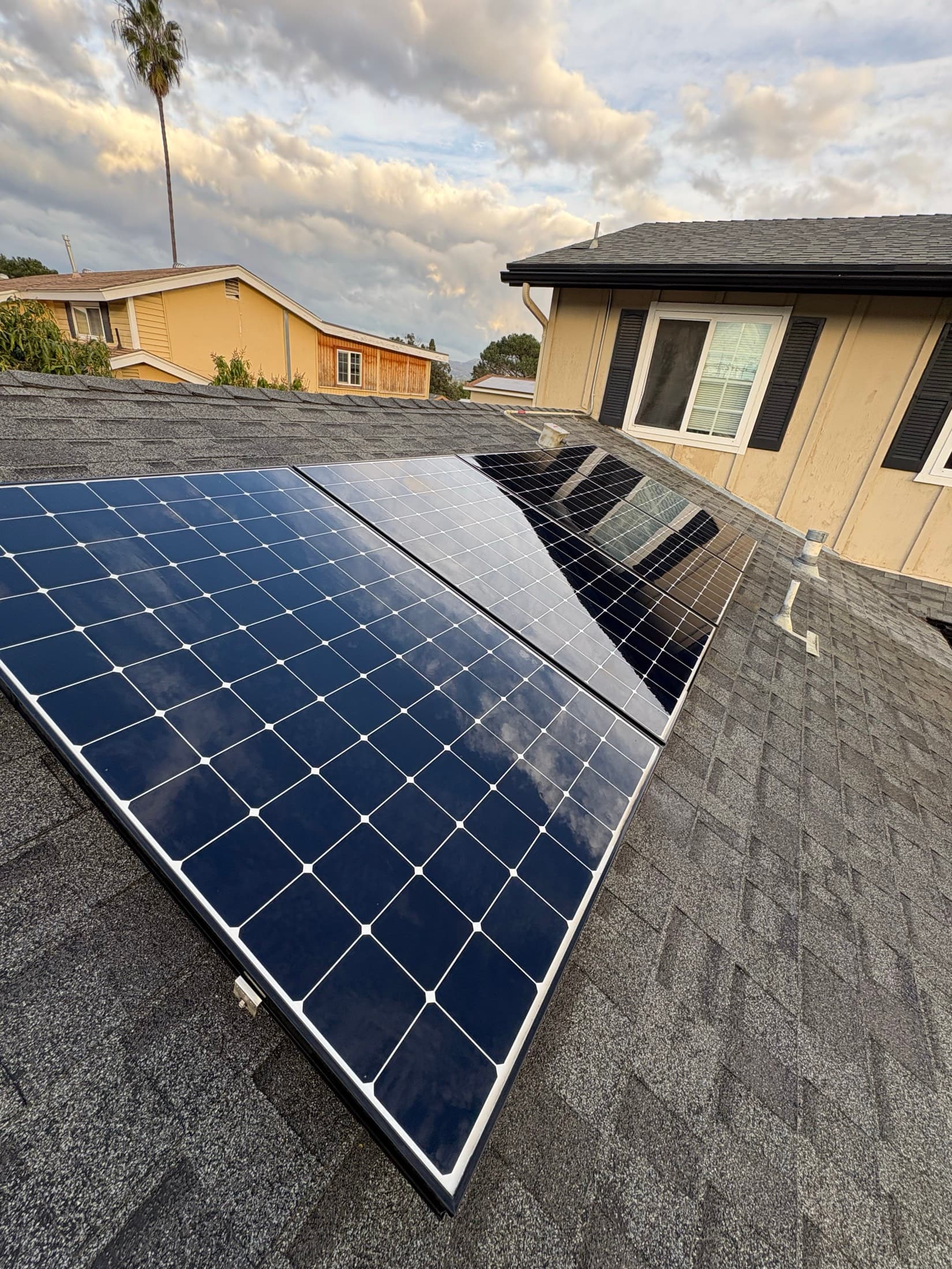 Solar panel cleaning on a shingle roof of an El Cajon home